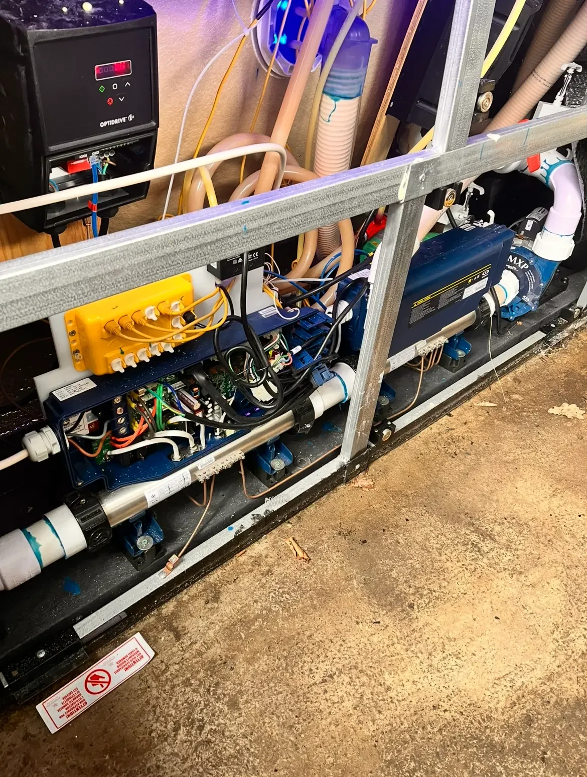Hot tub pumps and pipework exposed for careful maintenance